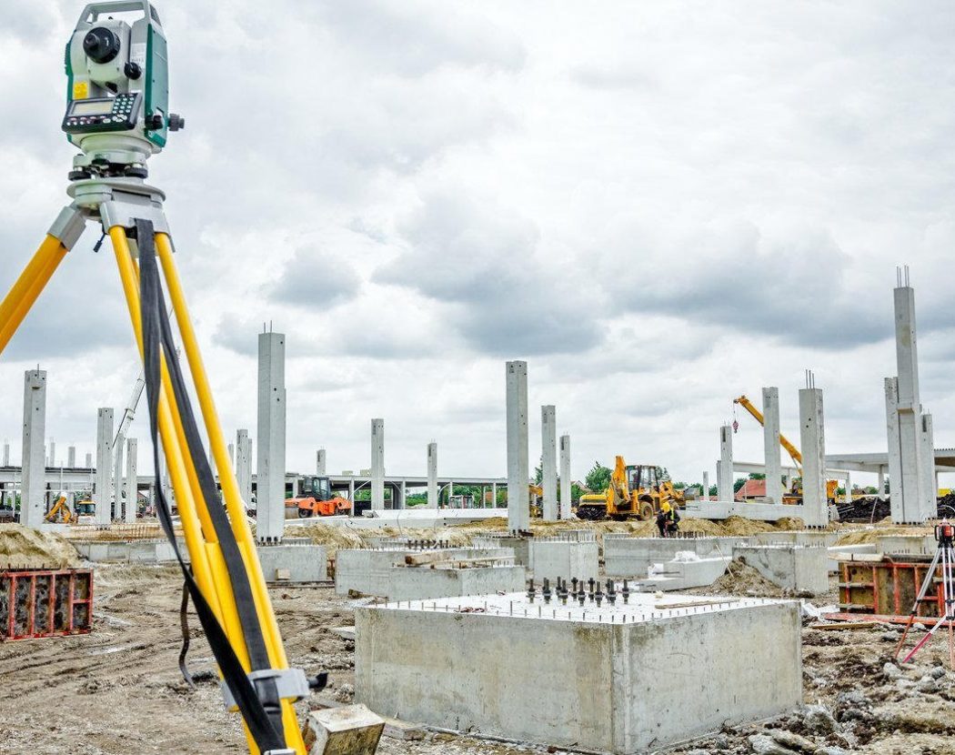 Survey instrument overlooking a construction site
